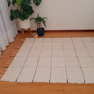 large cream rug with black line squares